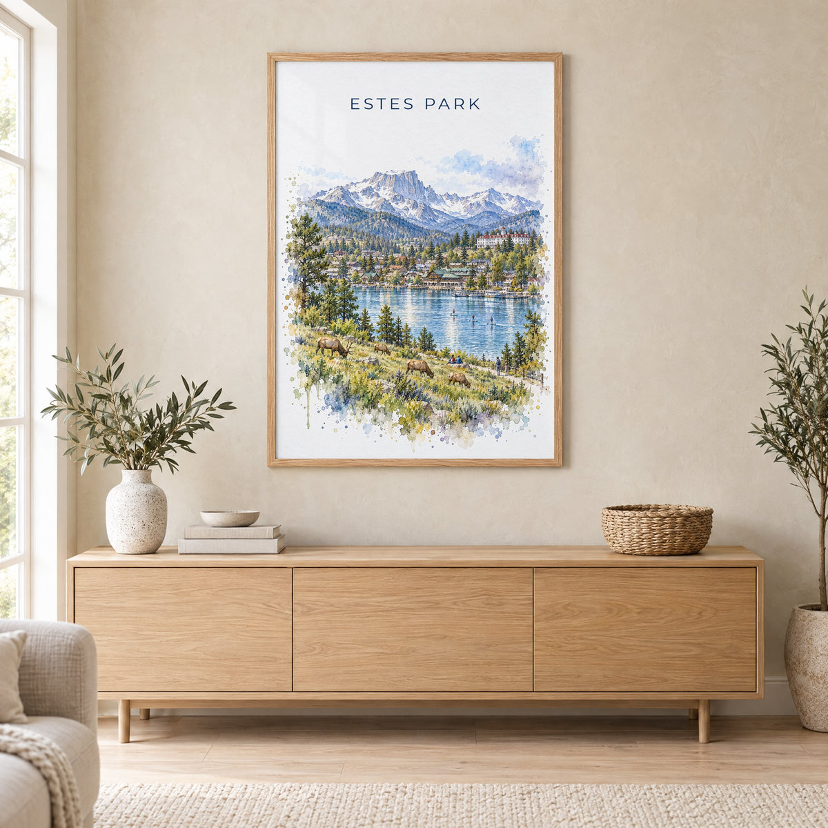 Estes Park watercolor print in an oak frame above a light wood sideboard in a Scandinavian living room