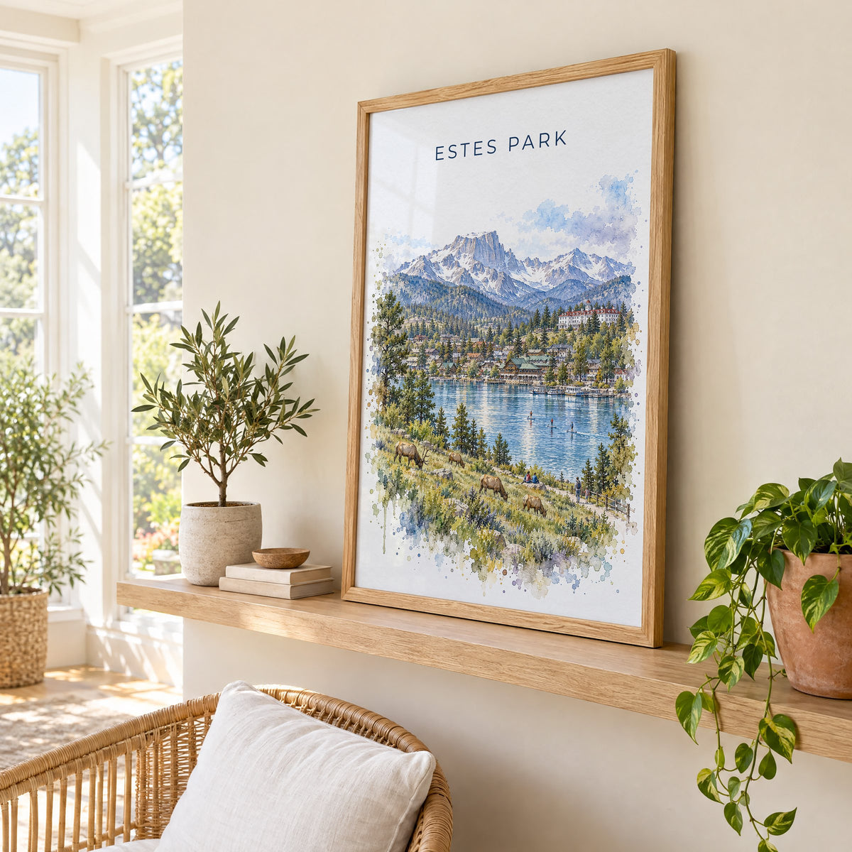 Estes Park watercolor print in an oak frame on a picture ledge in a sunlit sunroom