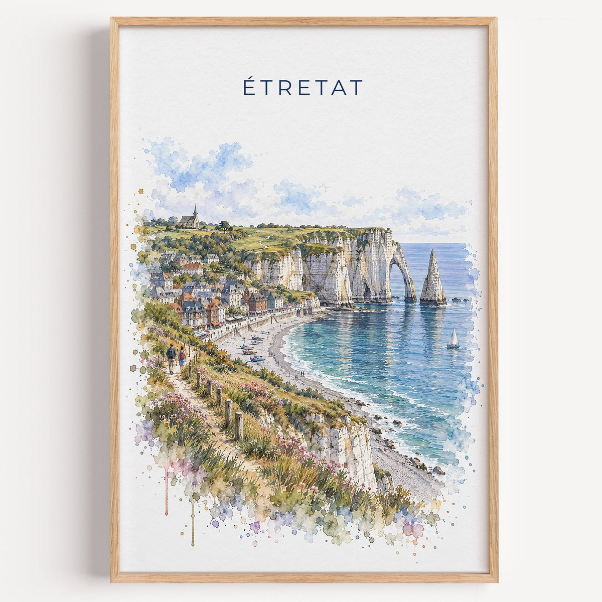Étretat watercolor print in a light oak frame on a plain white wall