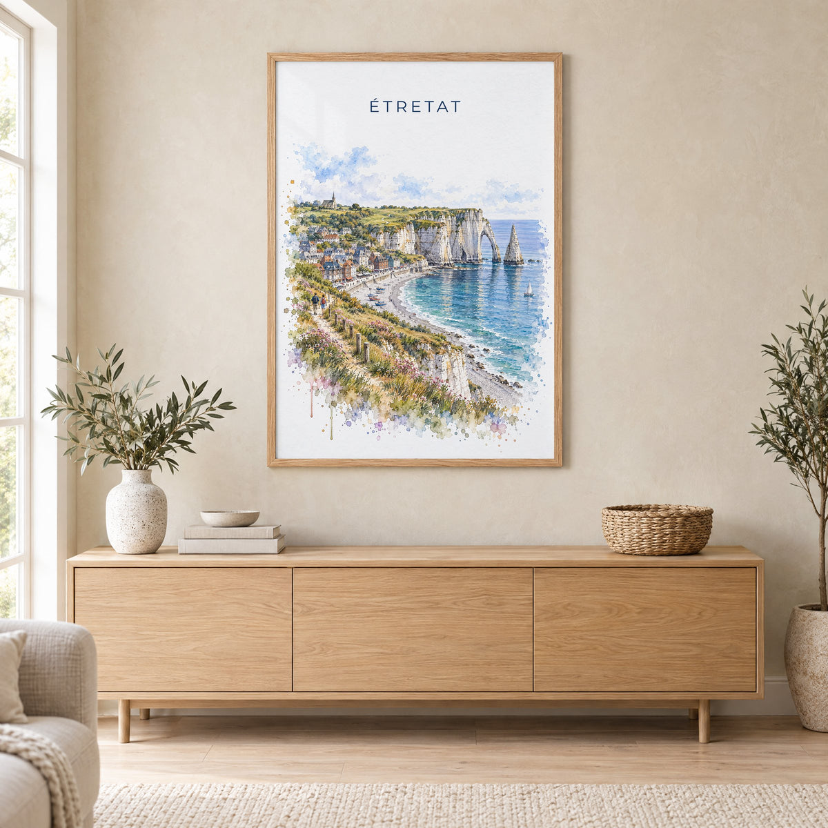 Étretat watercolor print in an oak frame above a light wood sideboard in a Scandinavian living room