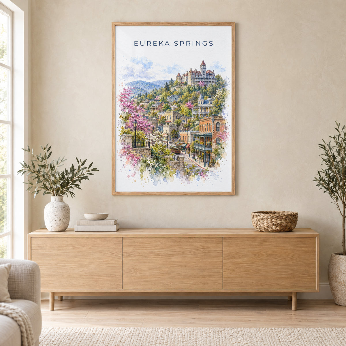 Eureka Springs watercolor print in an oak frame above a light wood sideboard in a Scandinavian living room