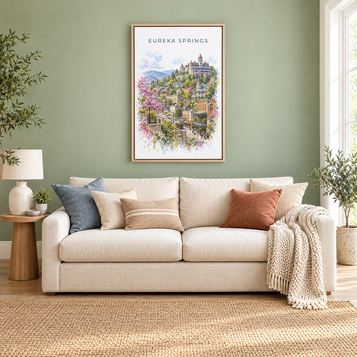 Eureka Springs watercolor print as a natural floater canvas above a cream linen sofa on a sage green wall
