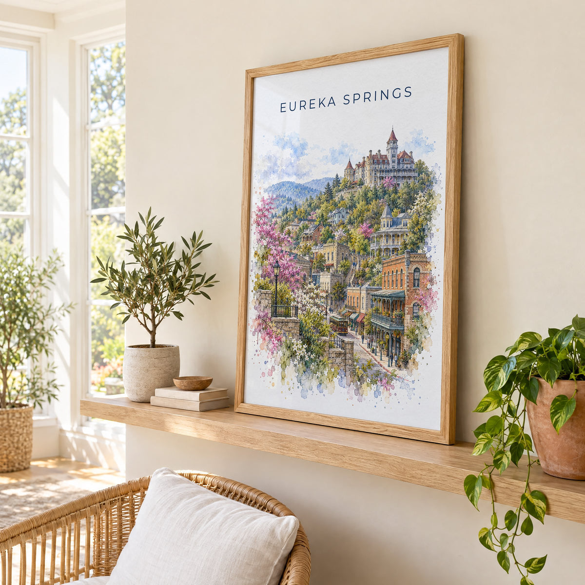 Eureka Springs watercolor print in an oak frame on a picture ledge in a sunlit sunroom