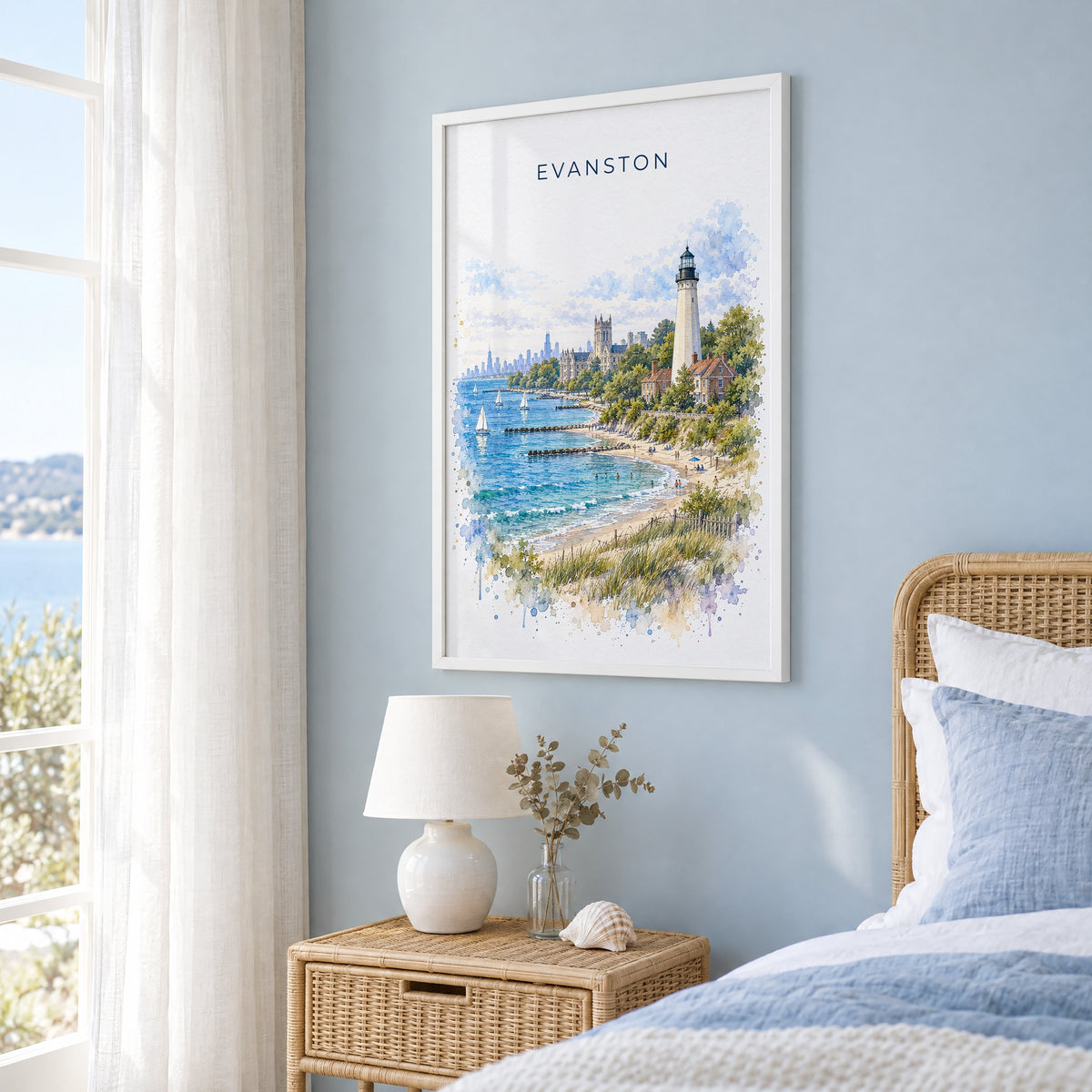 Evanston watercolor print in a white frame on a pale blue wall beside a rattan bed in a coastal bedroom