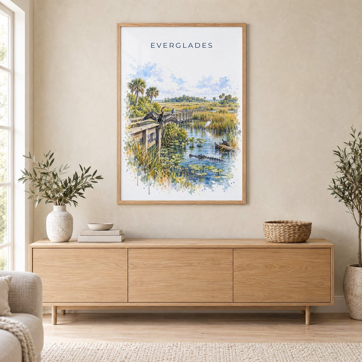 Everglades National Park watercolor print in an oak frame above a light wood sideboard in a Scandinavian living room