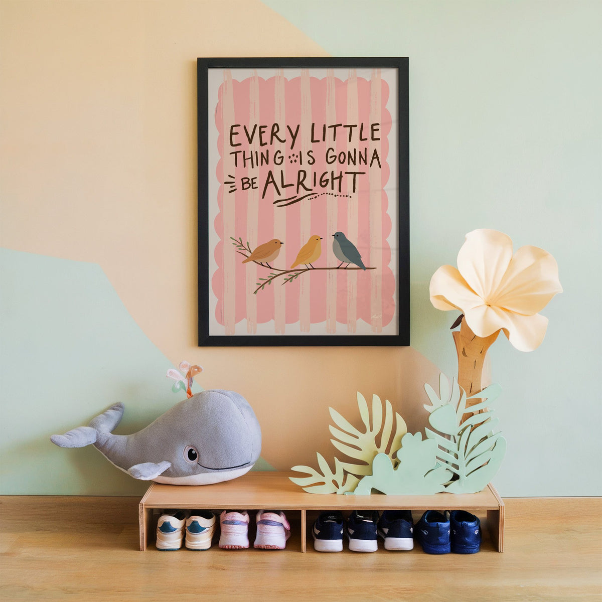 Every little thing birds quote nursery print in a black frame on a mint and peach wall above a whale plush