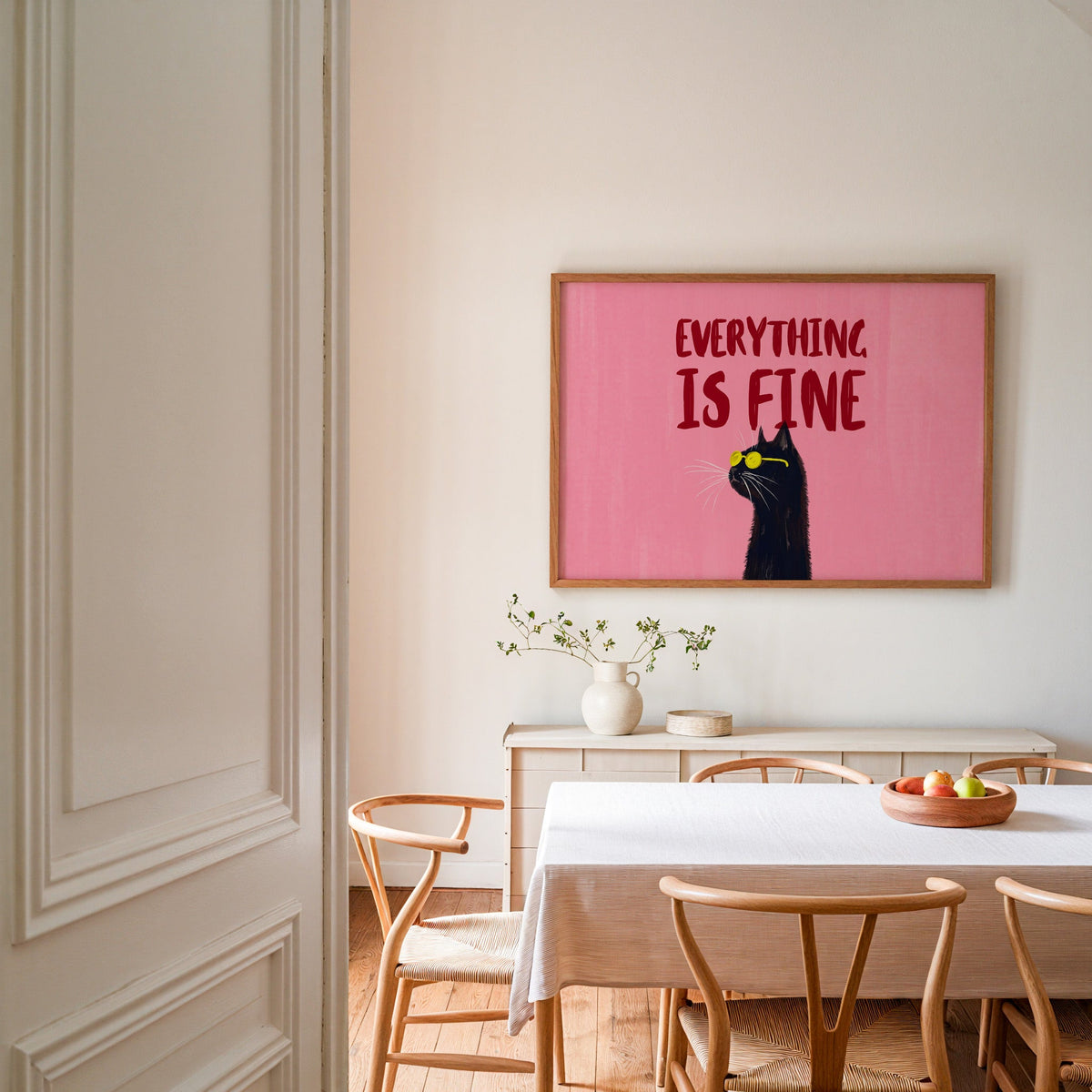 Everything Is Fine quote print in an oak frame in a dining room with wishbone chairs