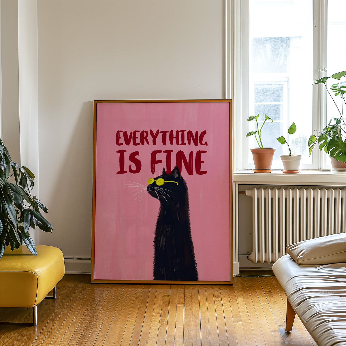 Black cat quote print in an oak frame leaning beside a yellow leather bench