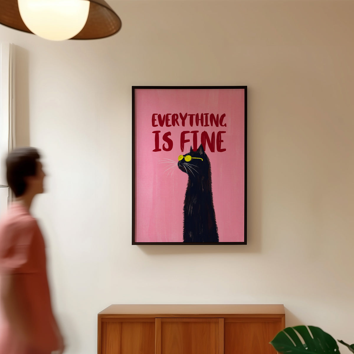 Everything Is Fine cat poster in a black frame in a hallway under a rattan pendant