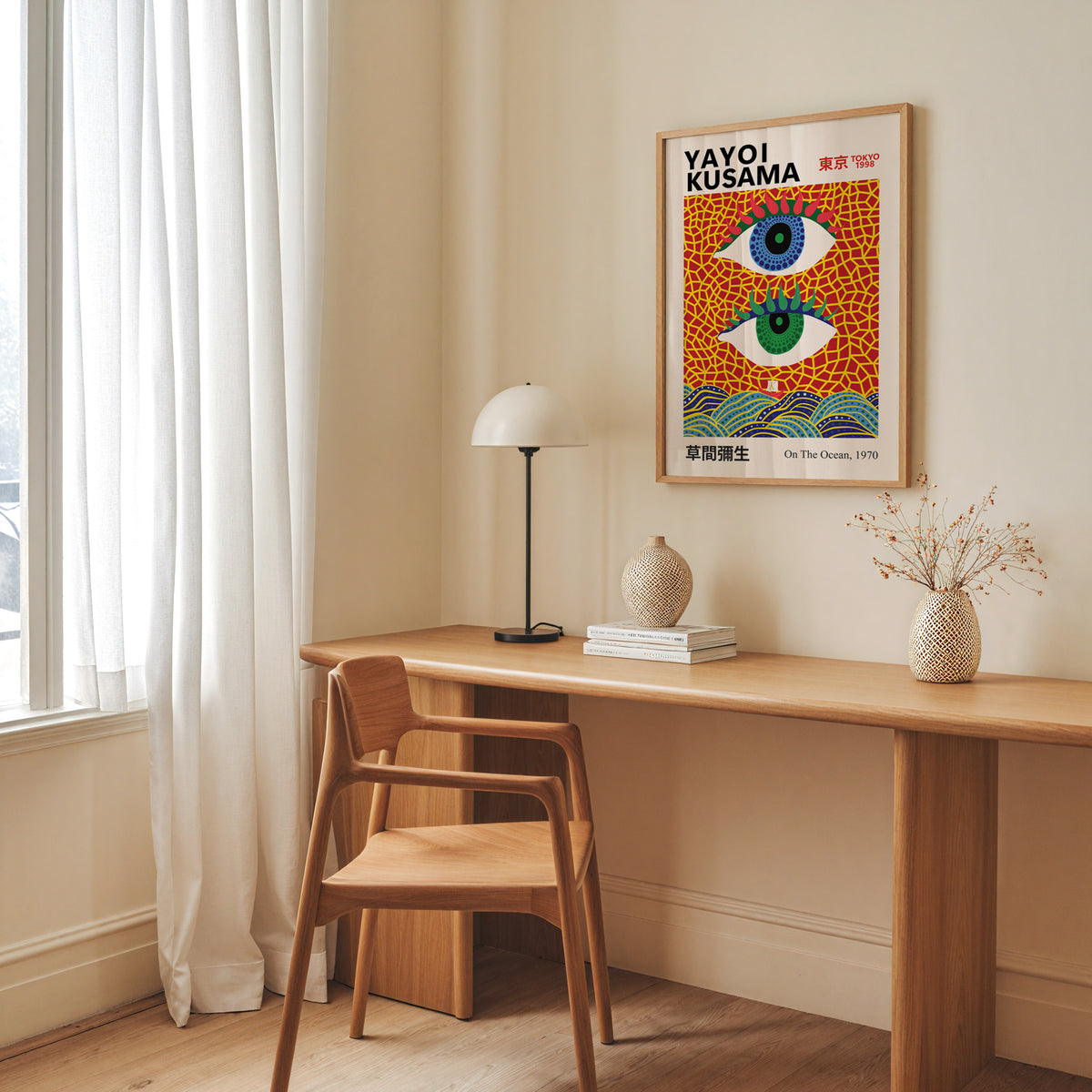 Yayoi Kusama inspired evil eyes and waves print above a desk with a dome lamp