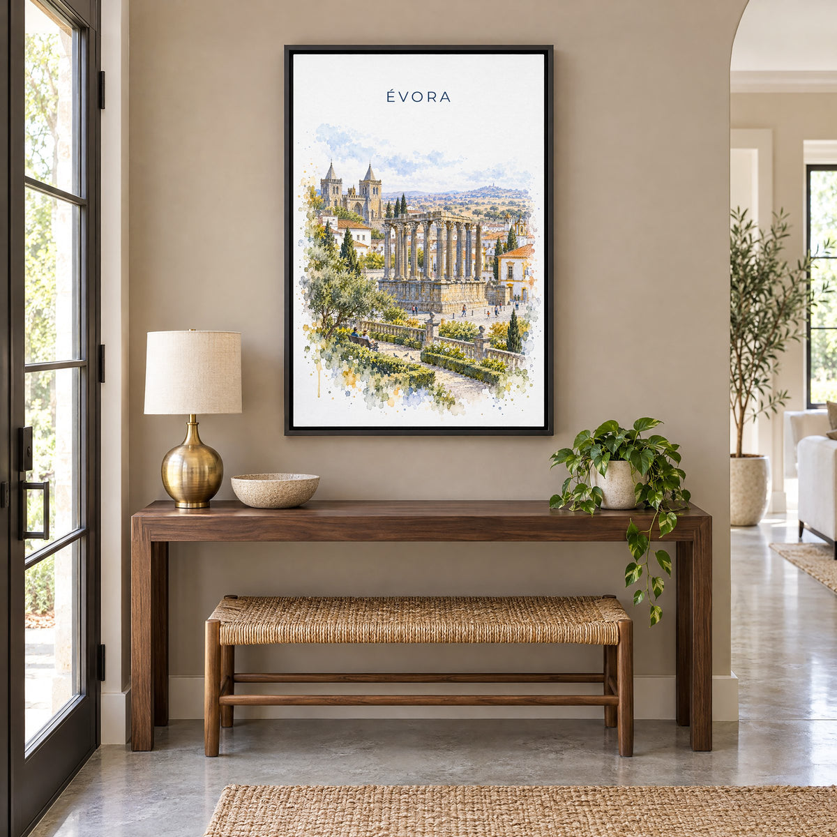 Évora watercolor print as a black floater canvas above a walnut console and woven bench in an entryway