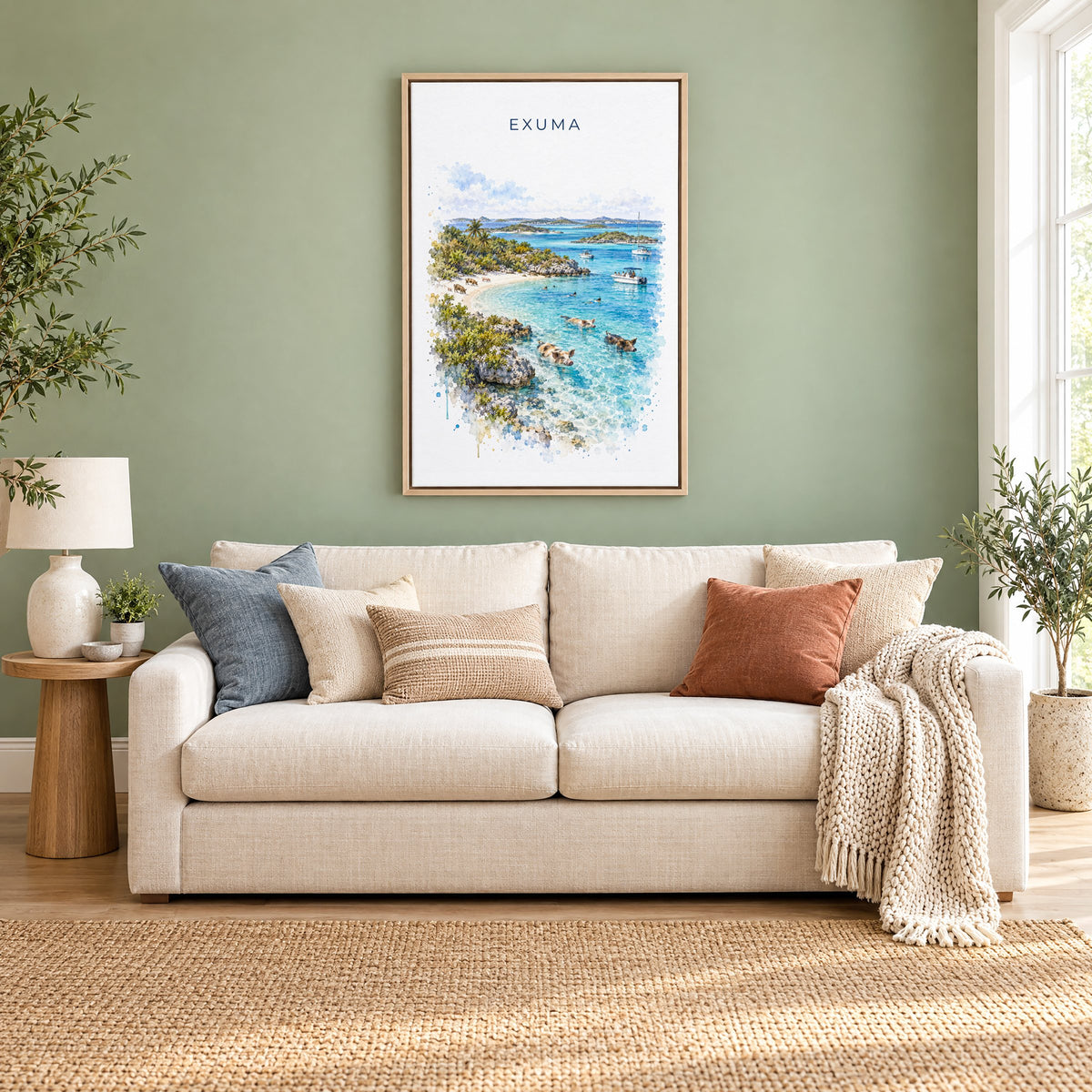 Exuma watercolor print as a natural floater canvas above a cream linen sofa on a sage green wall