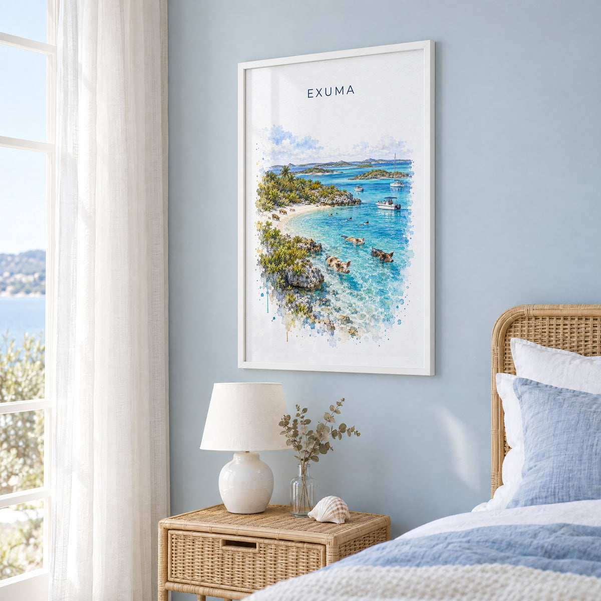 Exuma watercolor print in a white frame on a pale blue wall beside a rattan bed in a coastal bedroom