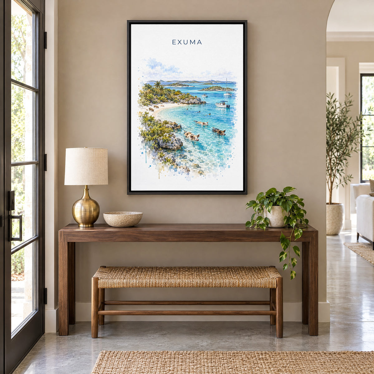 Exuma watercolor print as a black floater canvas above a walnut console and woven bench in an entryway