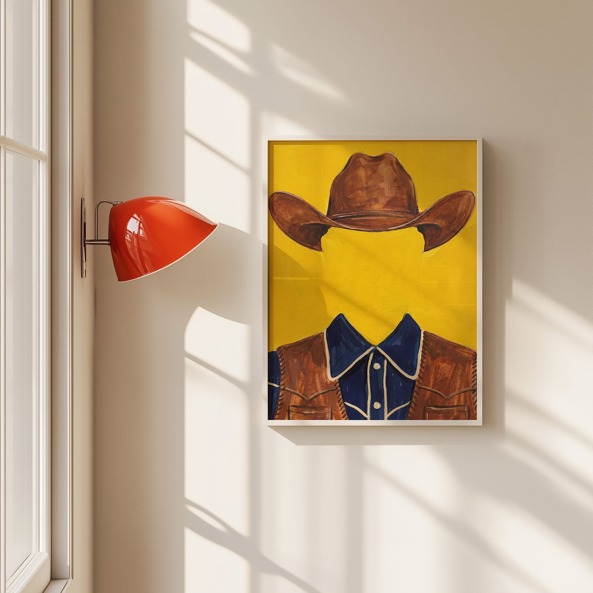 Faceless cowboy print in a white frame beside a red wall sconce