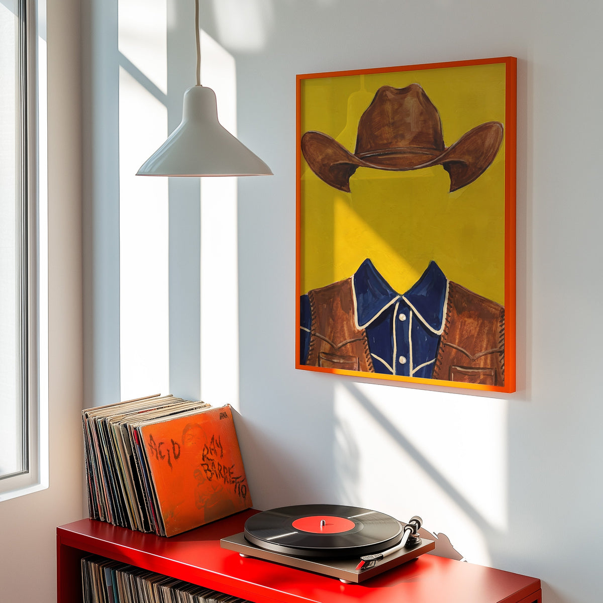 Modern western portrait print shown in an orange frame above a red record cabinet and turntable