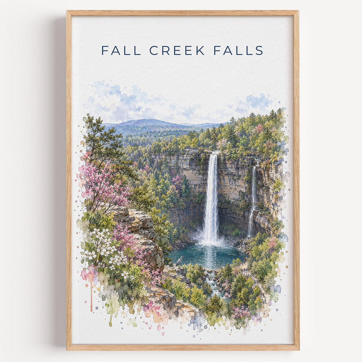 Fall Creek Falls watercolor print in a light oak frame on a plain white wall