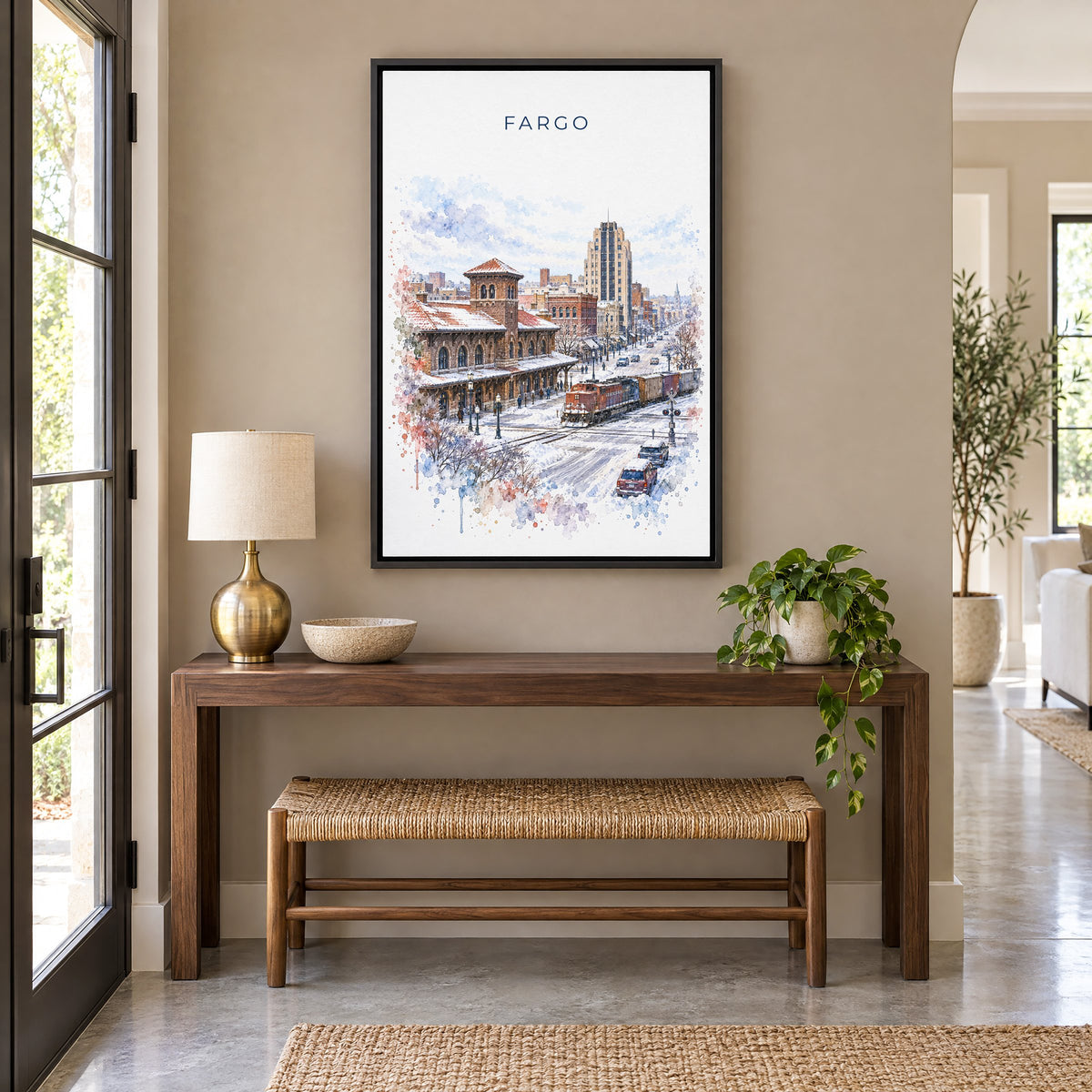 Fargo watercolor print as a black floater canvas above a walnut console and woven bench in an entryway
