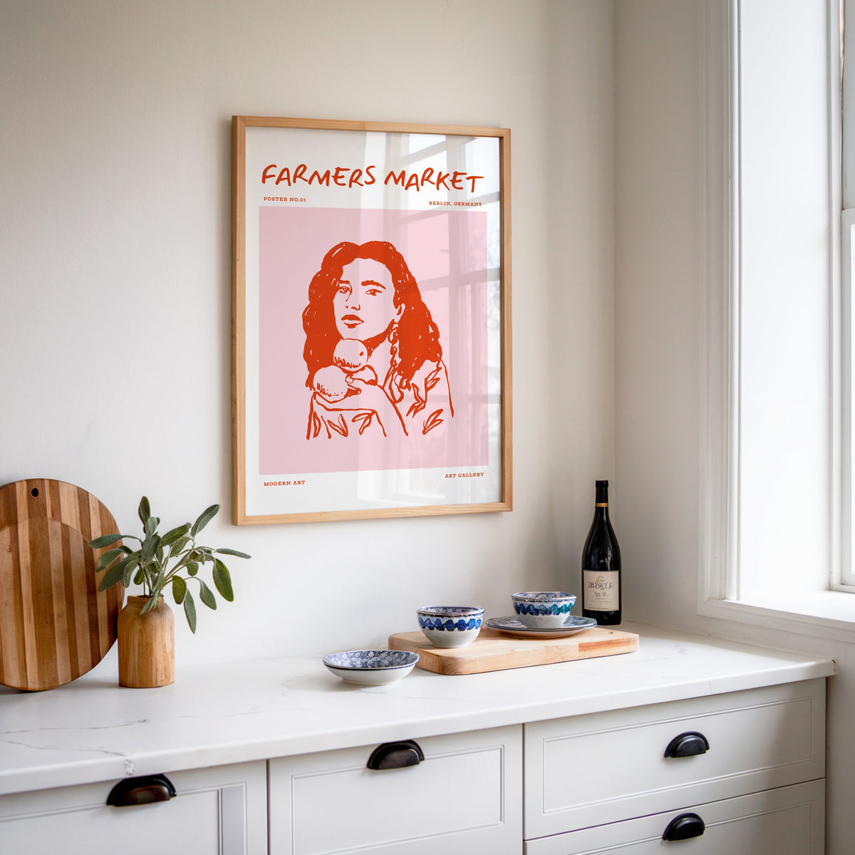 Farmers Market curly hair print in an oak frame above a kitchen sideboard