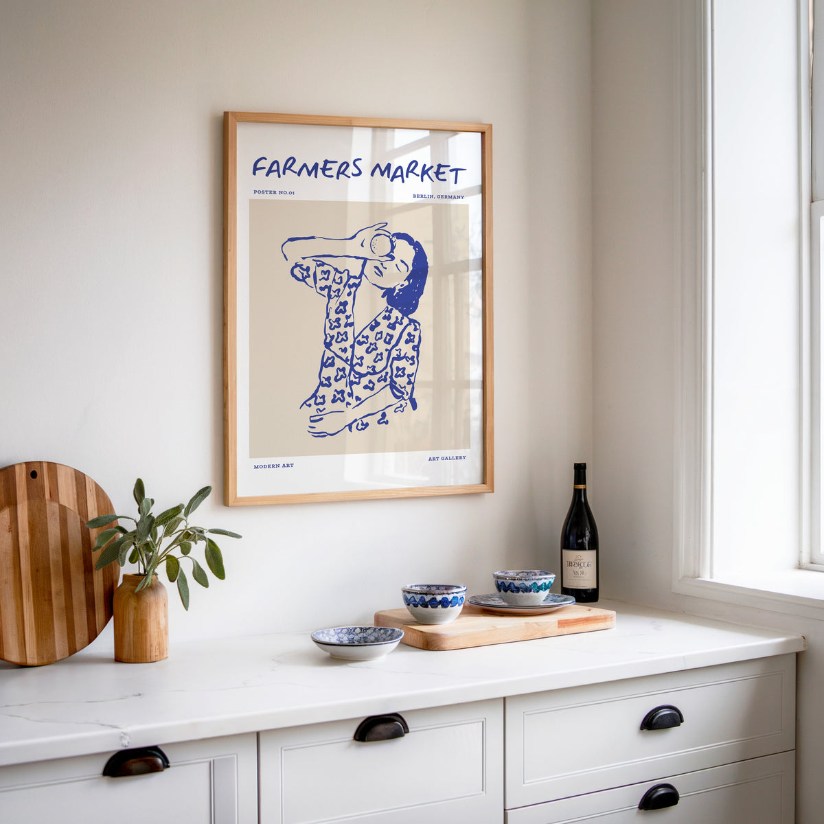Farmers Market portrait print in an oak frame above a white kitchen sideboard
