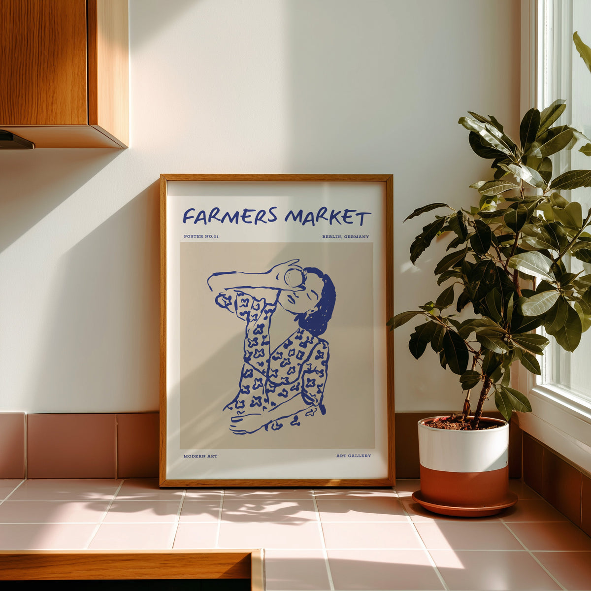 Farmers Market portrait print in an oak frame on pink tiles in afternoon sun