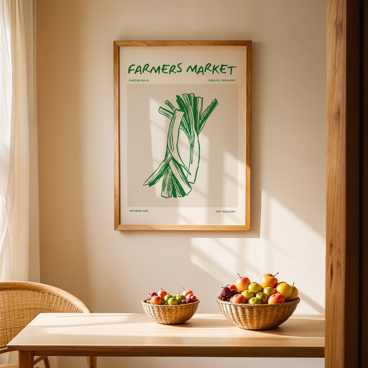 Green leeks print in an oak frame hanging above a dining table with rattan chairs