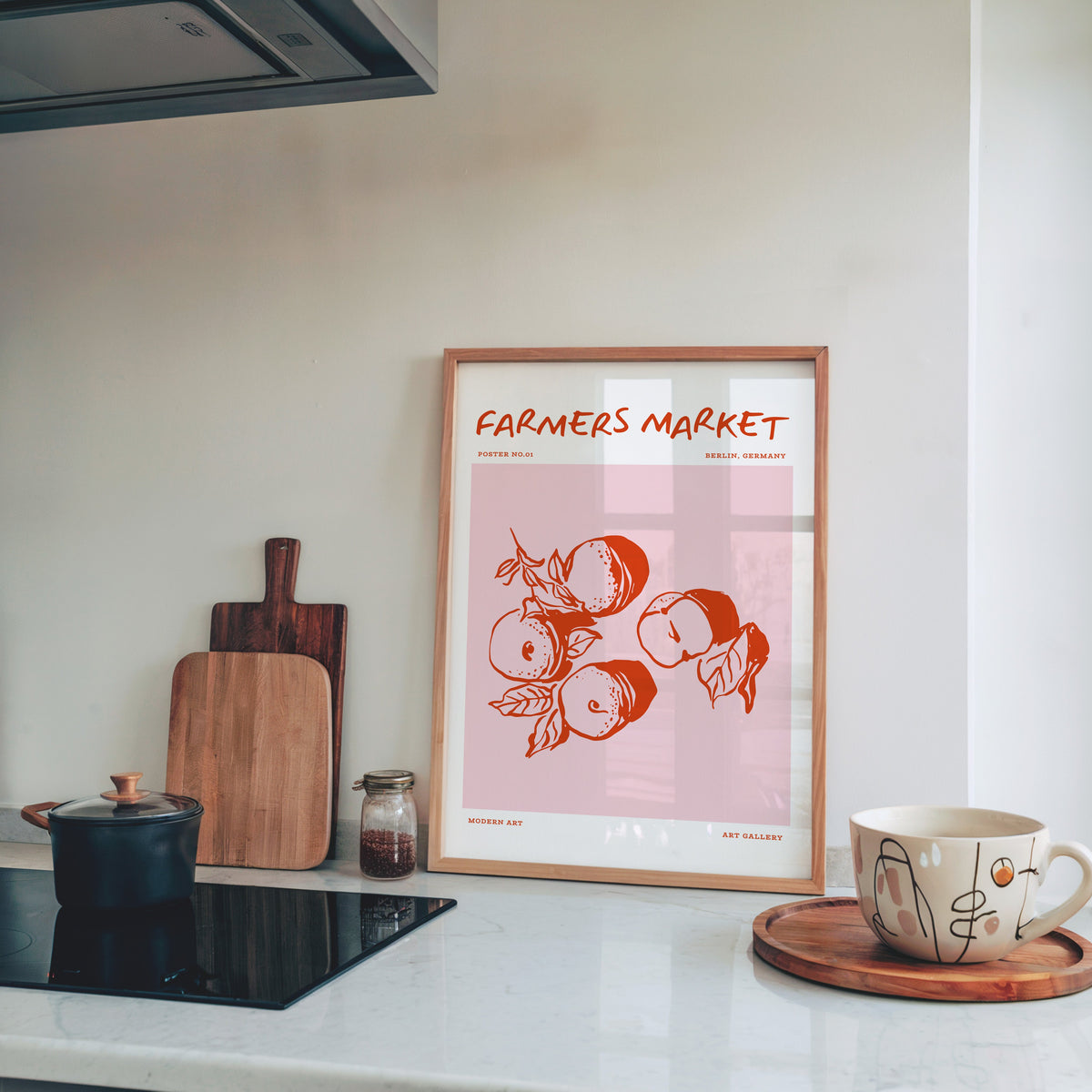 Farmers Market peaches print in a light pine frame leaning on a marble kitchen counter
