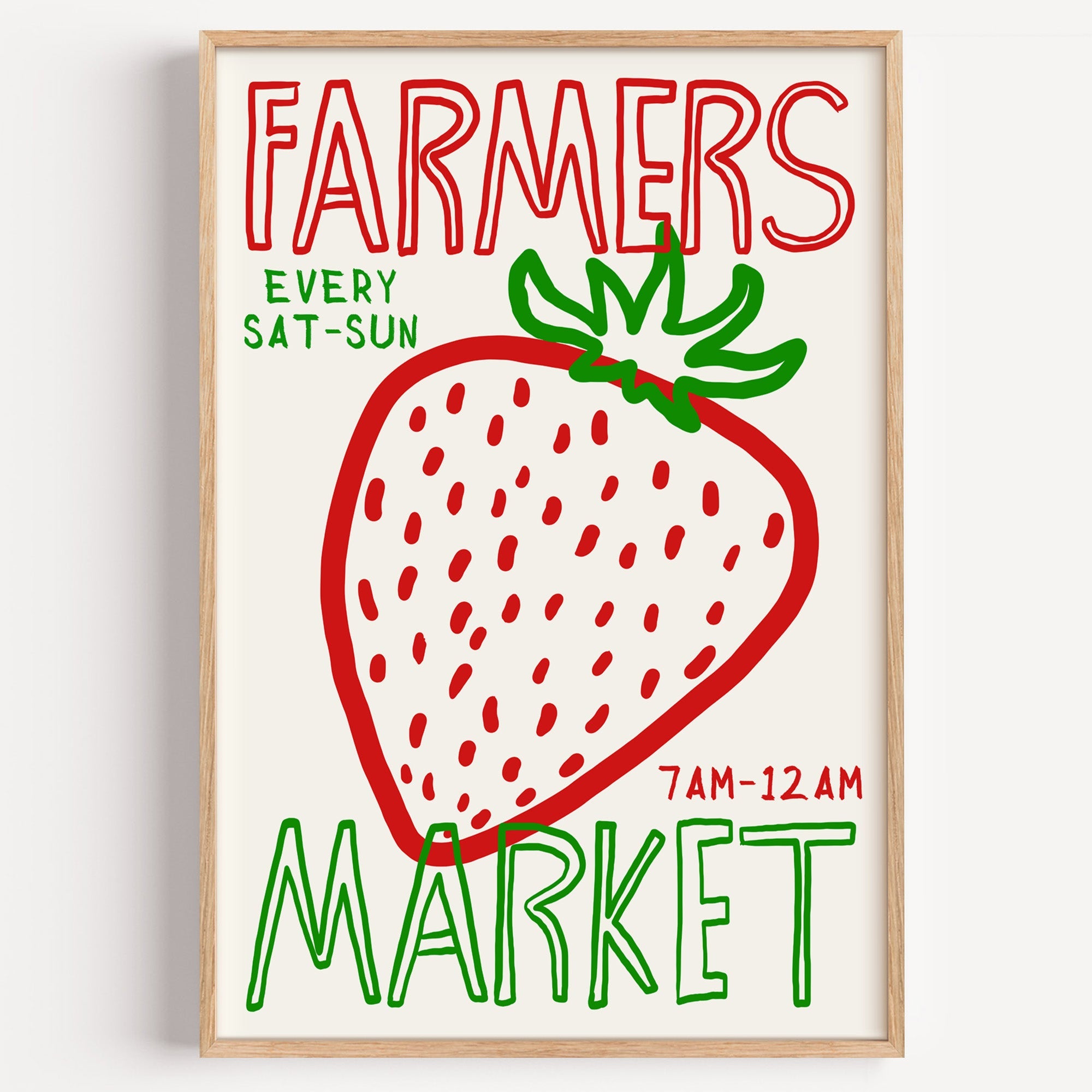 Farmers market strawberry print in a light oak frame on a plain white wall