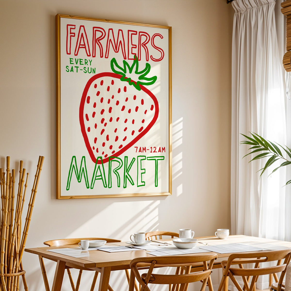 Farmers market strawberry print in a gold frame above a sunlit breakfast table