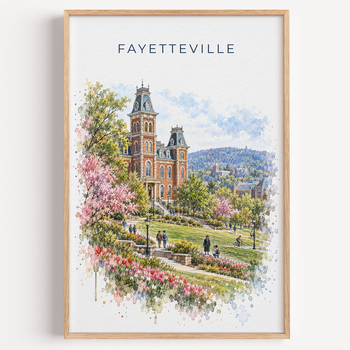Fayetteville, Arkansas watercolor print in a light oak frame on a plain white wall