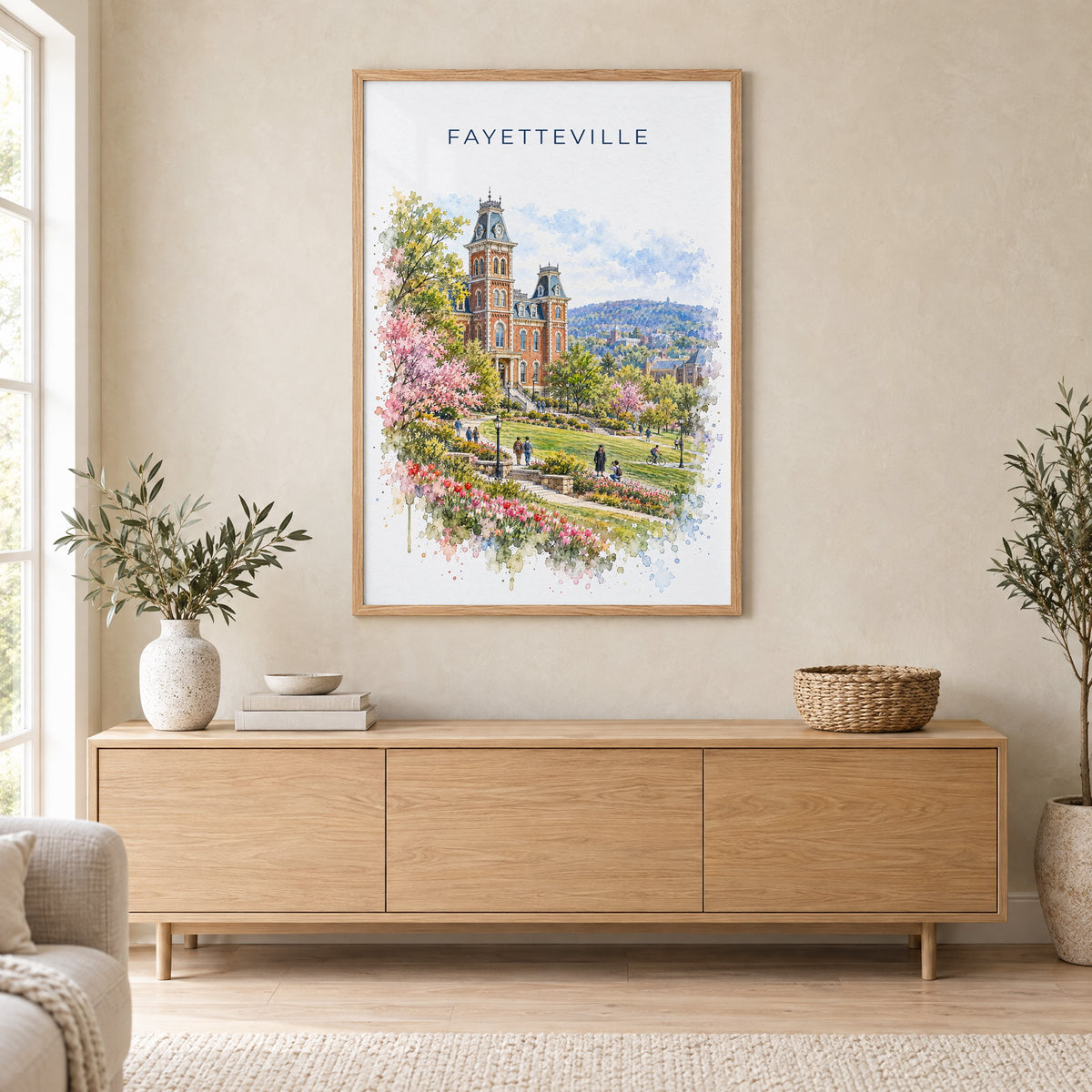 Fayetteville, Arkansas watercolor print in an oak frame above a light wood sideboard in a Scandinavian living room