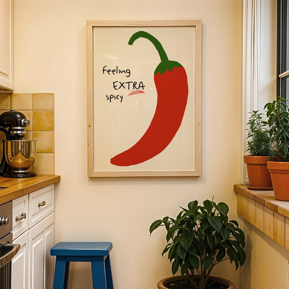 Feeling extra spicy chili print in a wood frame on a yellow tiled kitchen wall