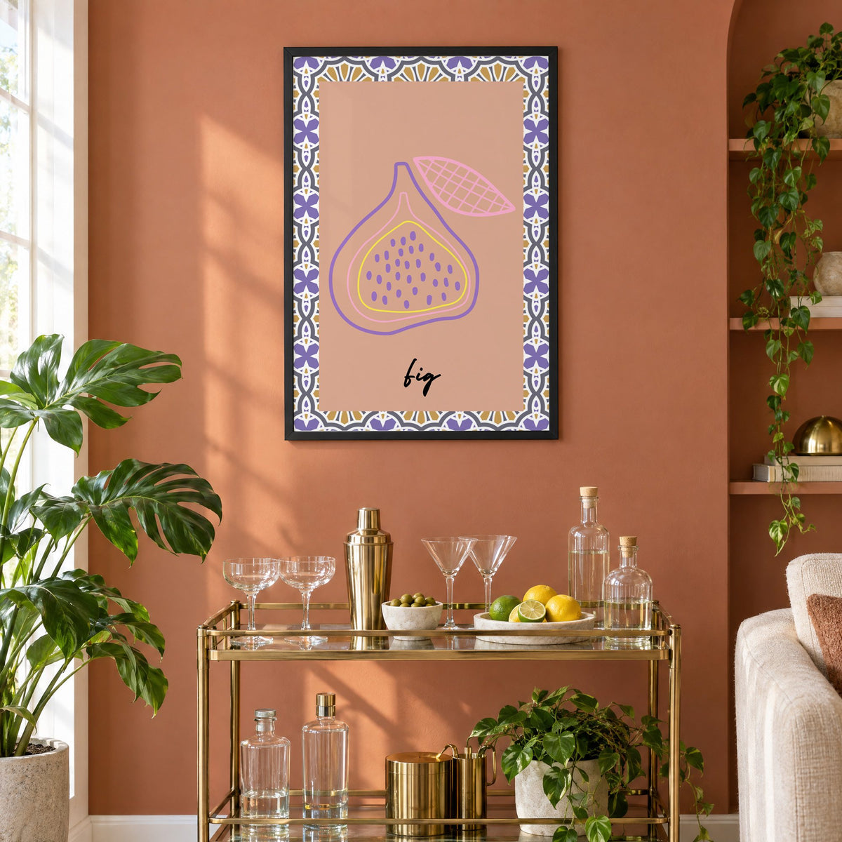 fig pastel outline purple tile print in a black frame on a terracotta wall above a brass bar cart with coupes and citrus