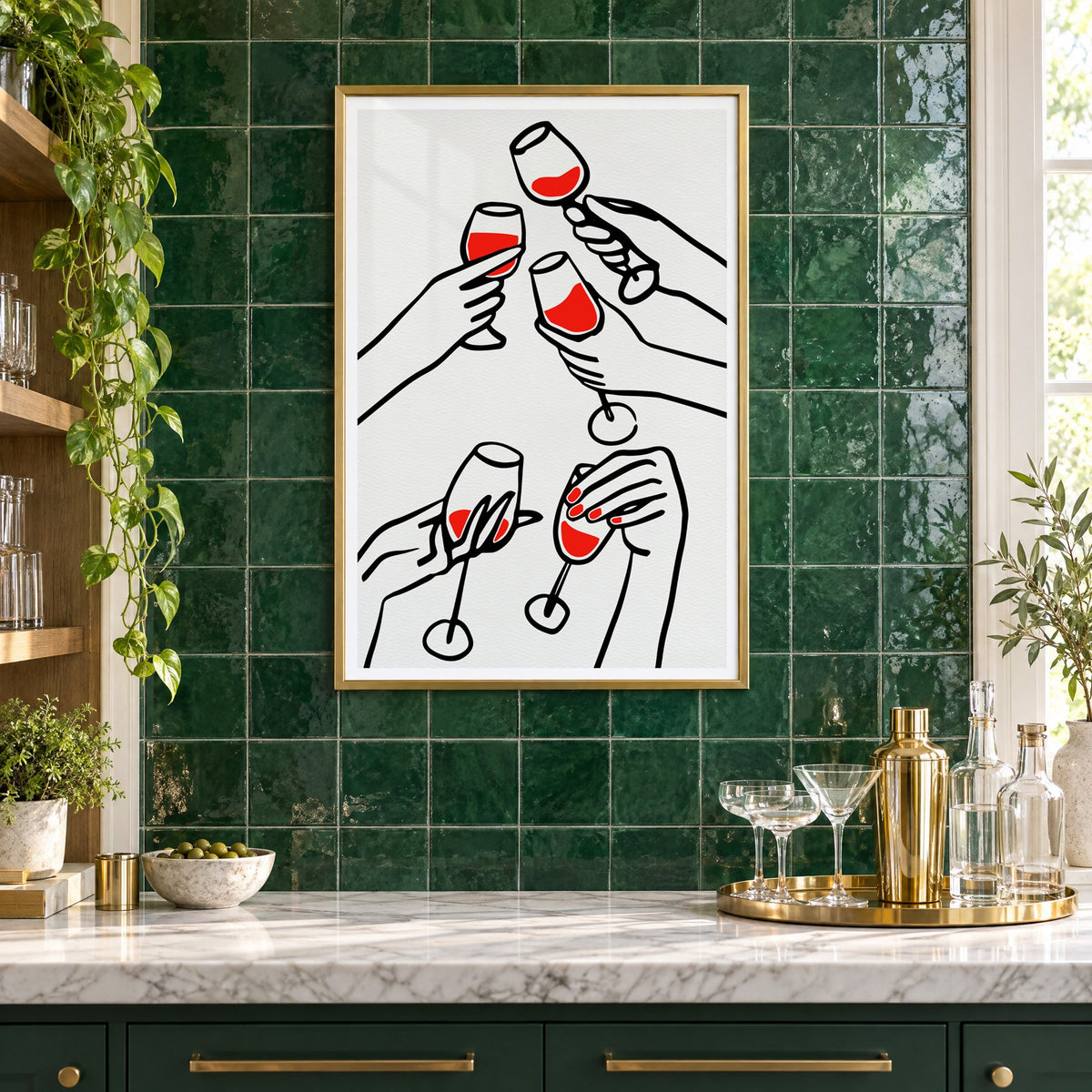 Five hands red wine toast line print in a brass frame on emerald green tiles above a home bar with coupe glasses