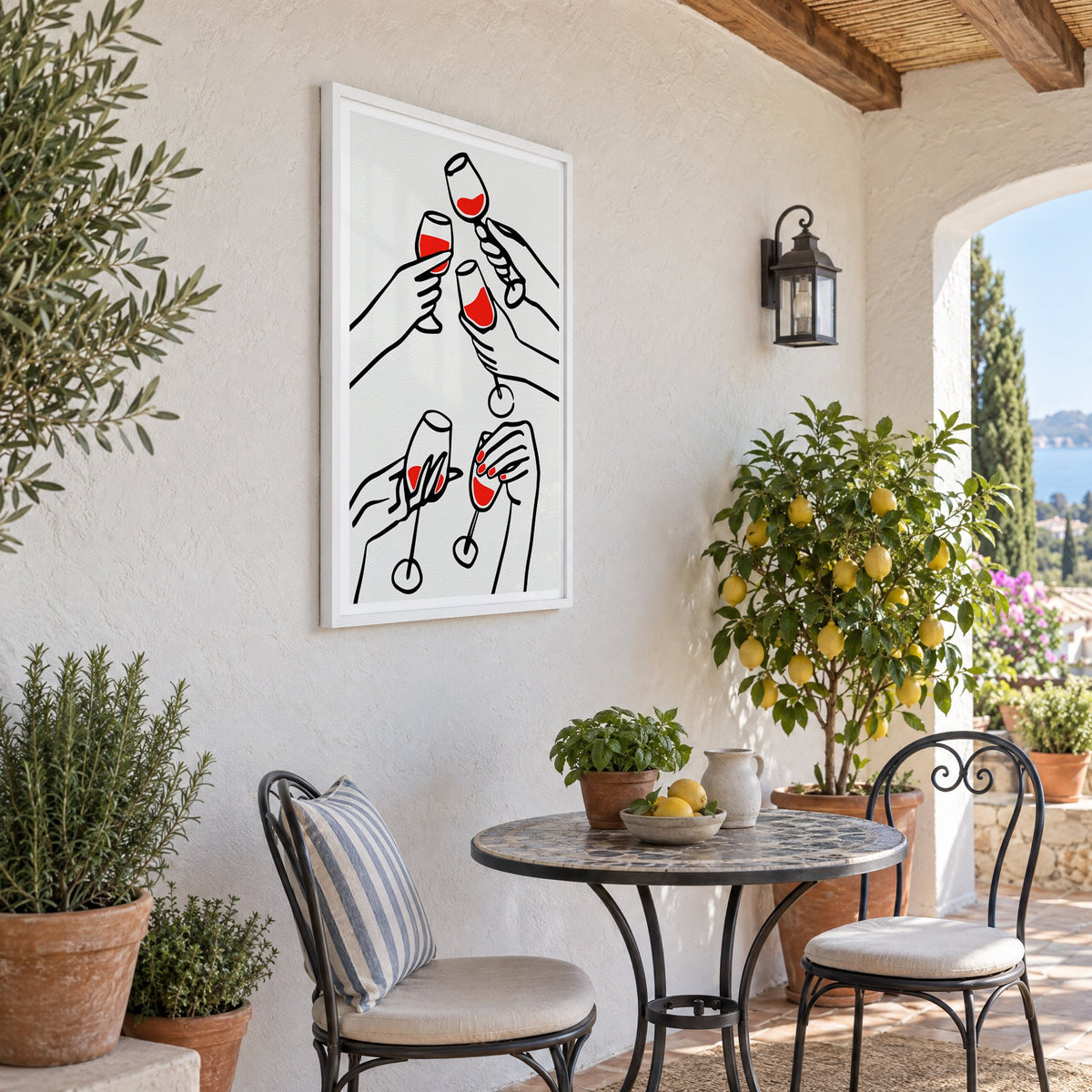 Five hands red wine toast line print in a white frame on a sunny patio wall beside a potted lemon tree