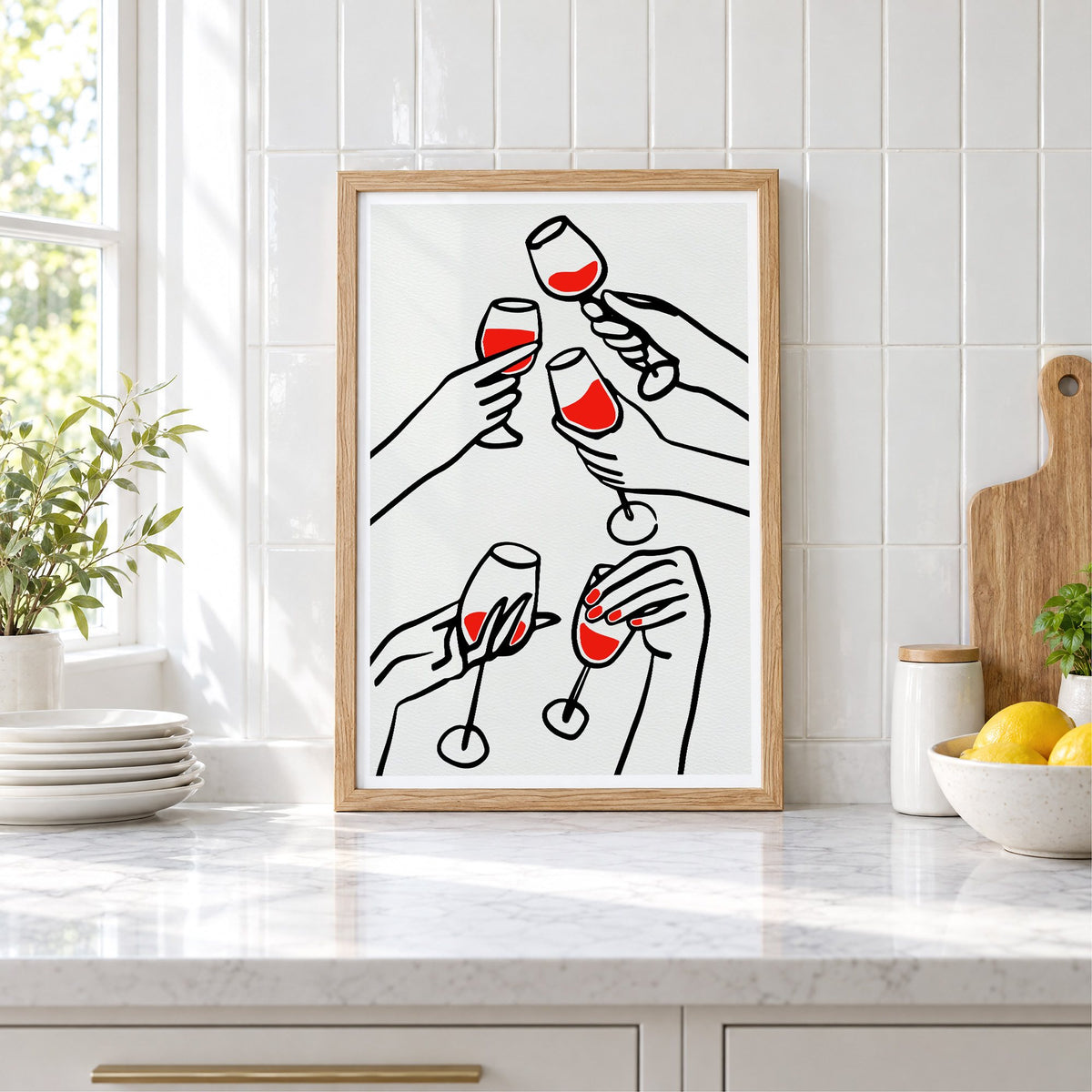 Five hands red wine toast line print in an oak frame leaning on a marble counter by white tiles and lemons