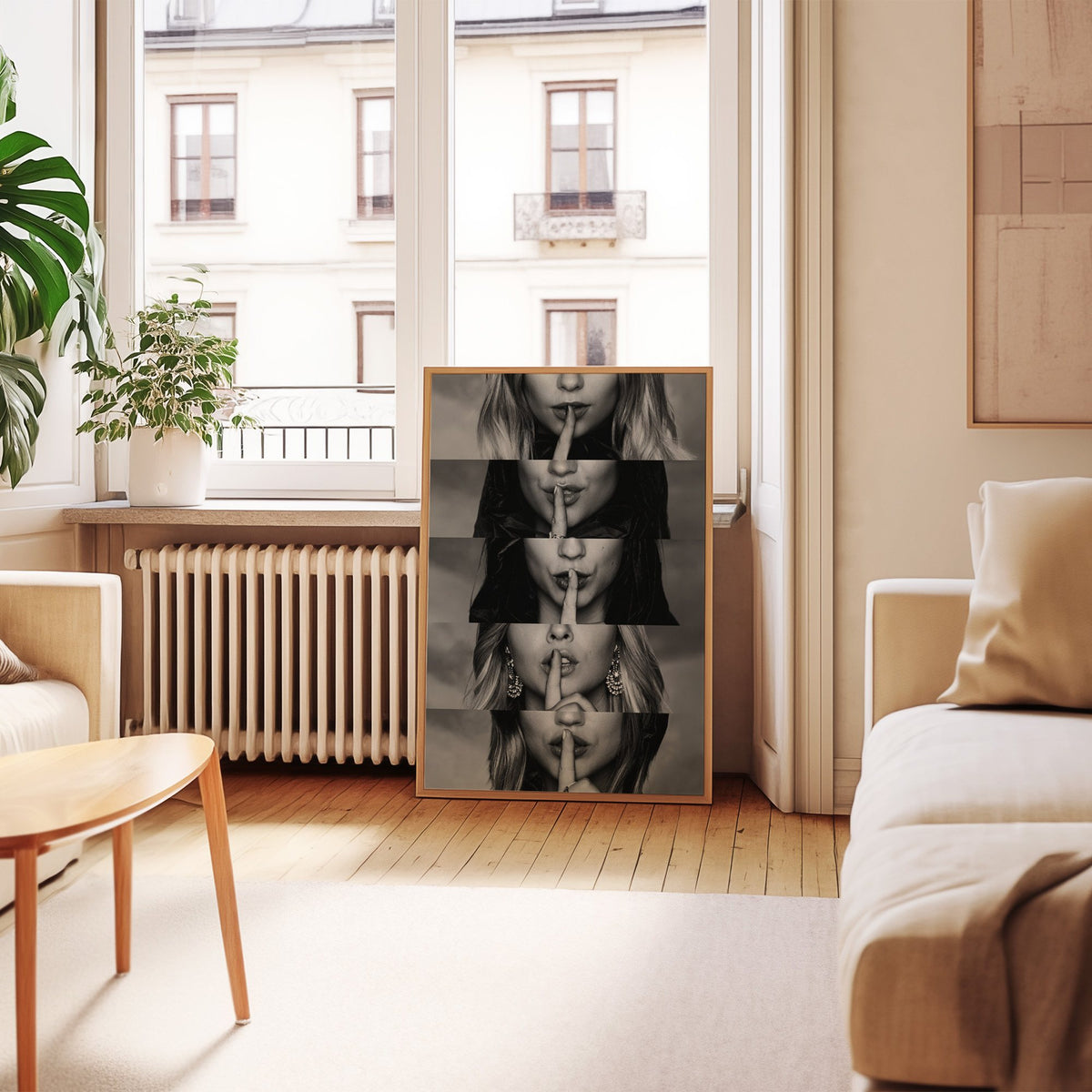 Five stacked strips of finger to lips hush print in an oak frame leaning by a French window in a living room