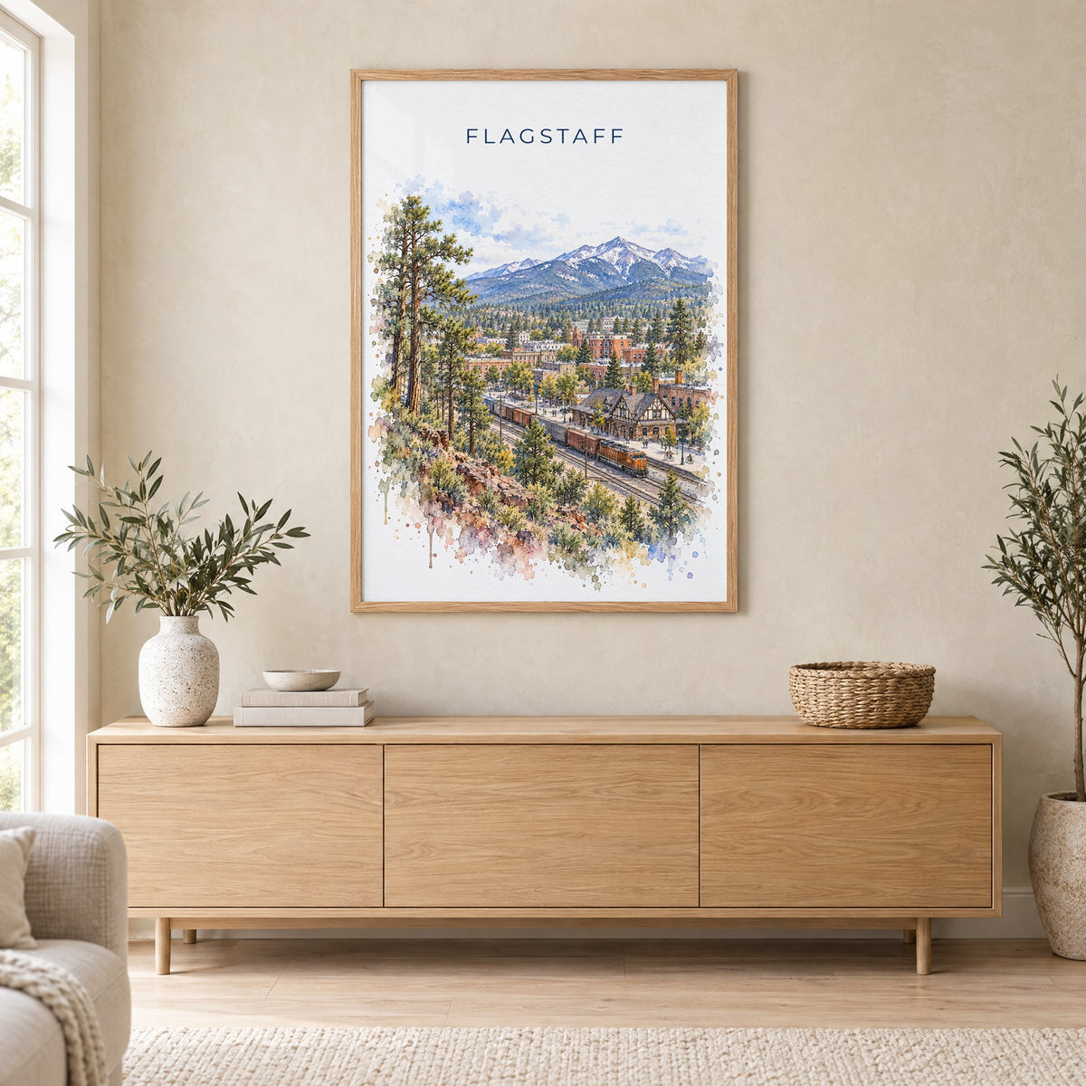 Flagstaff watercolor print in an oak frame above a light wood sideboard in a Scandinavian living room