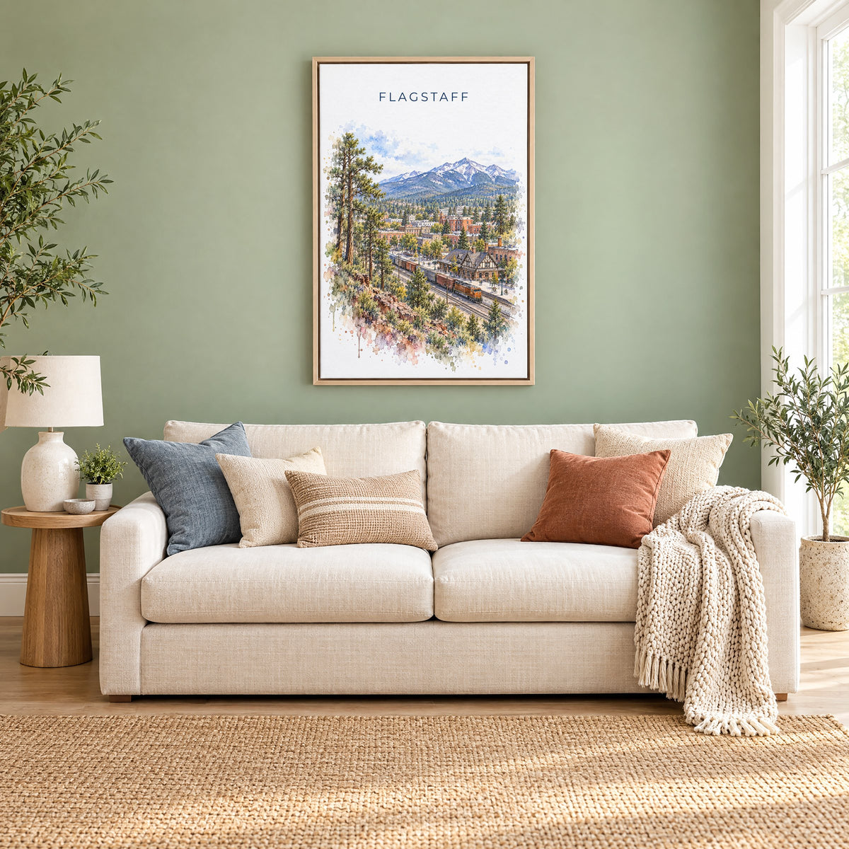 Flagstaff watercolor print as a natural floater canvas above a cream linen sofa on a sage green wall
