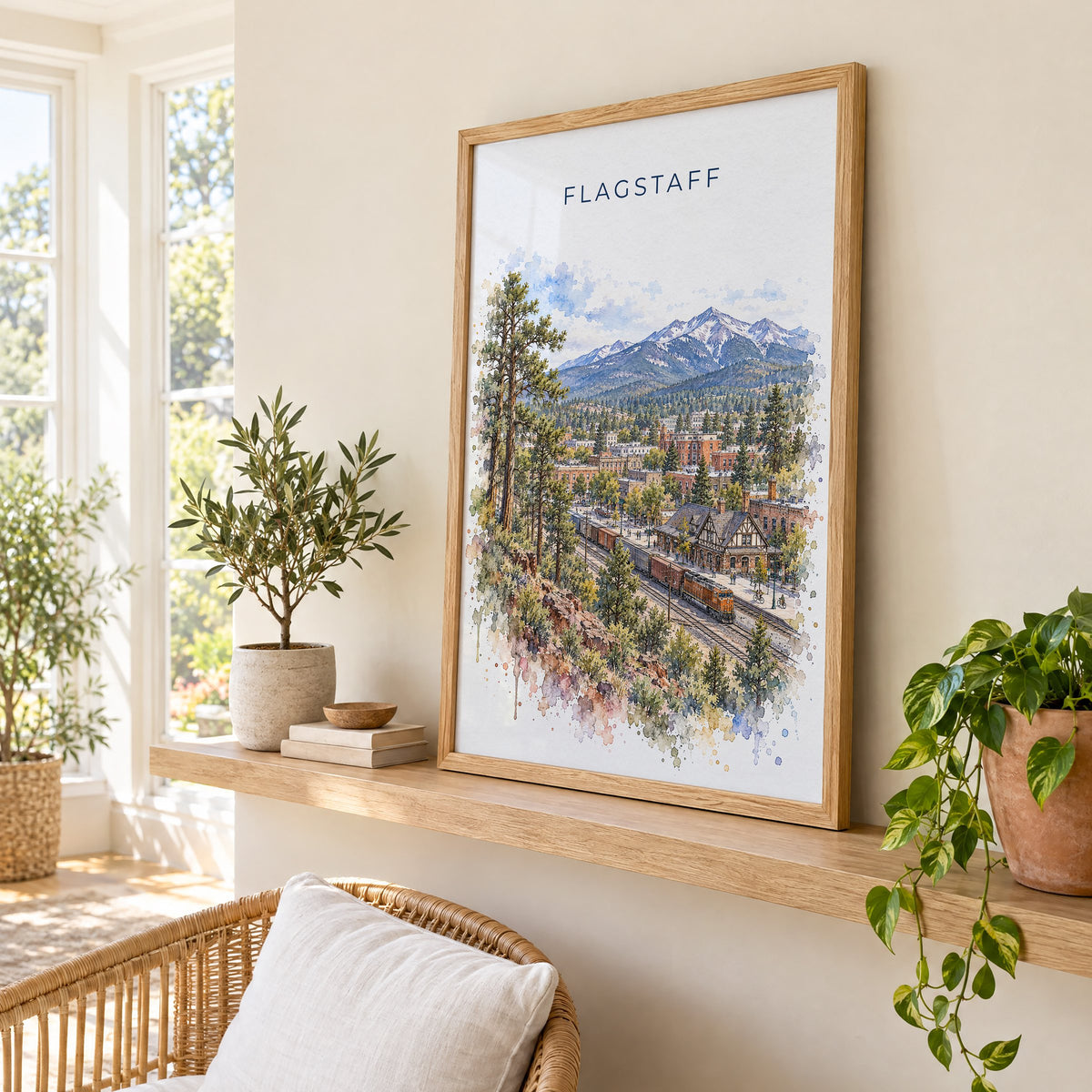 Flagstaff watercolor print in an oak frame on a picture ledge in a sunlit sunroom