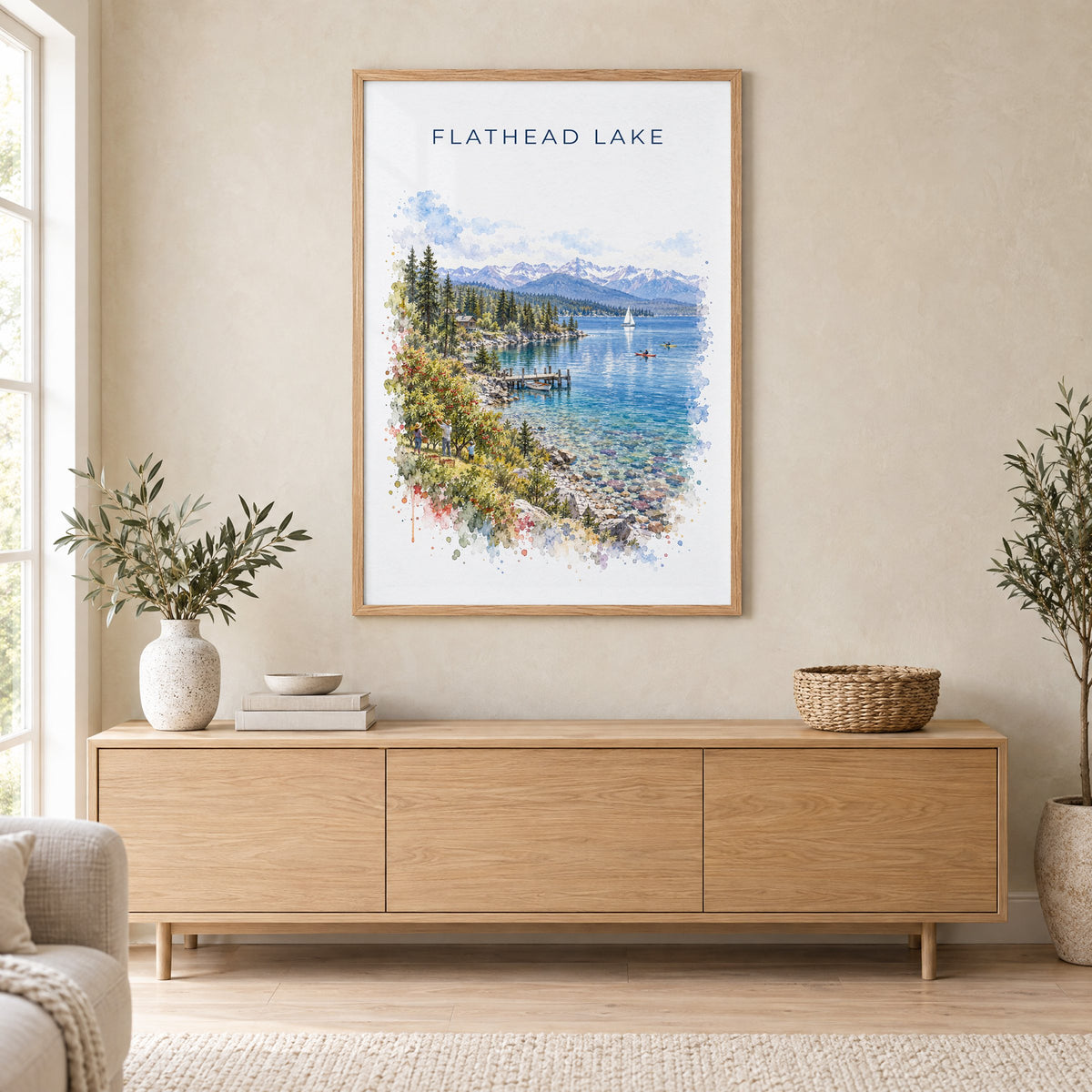 Flathead Lake watercolor print in an oak frame above a light wood sideboard in a Scandinavian living room