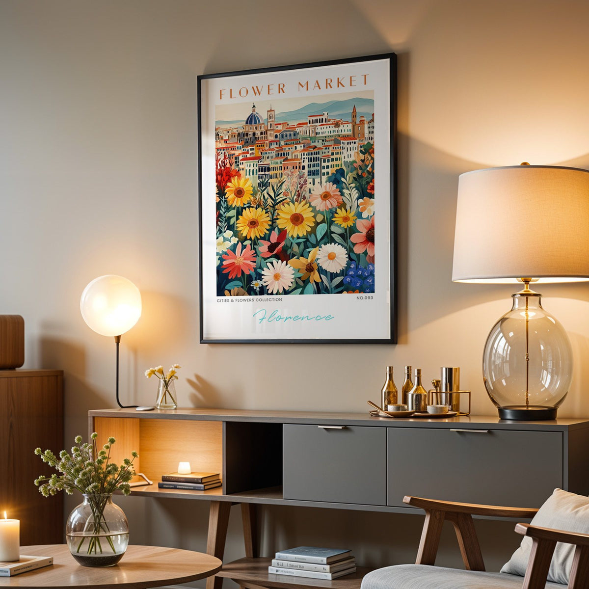 Florence flower market print in a black frame above a grey media console with a glass table lamp