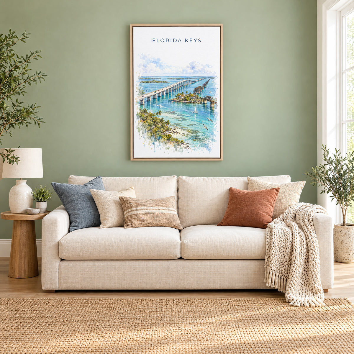 Florida Keys watercolor print as a natural floater canvas above a cream linen sofa on a sage green wall