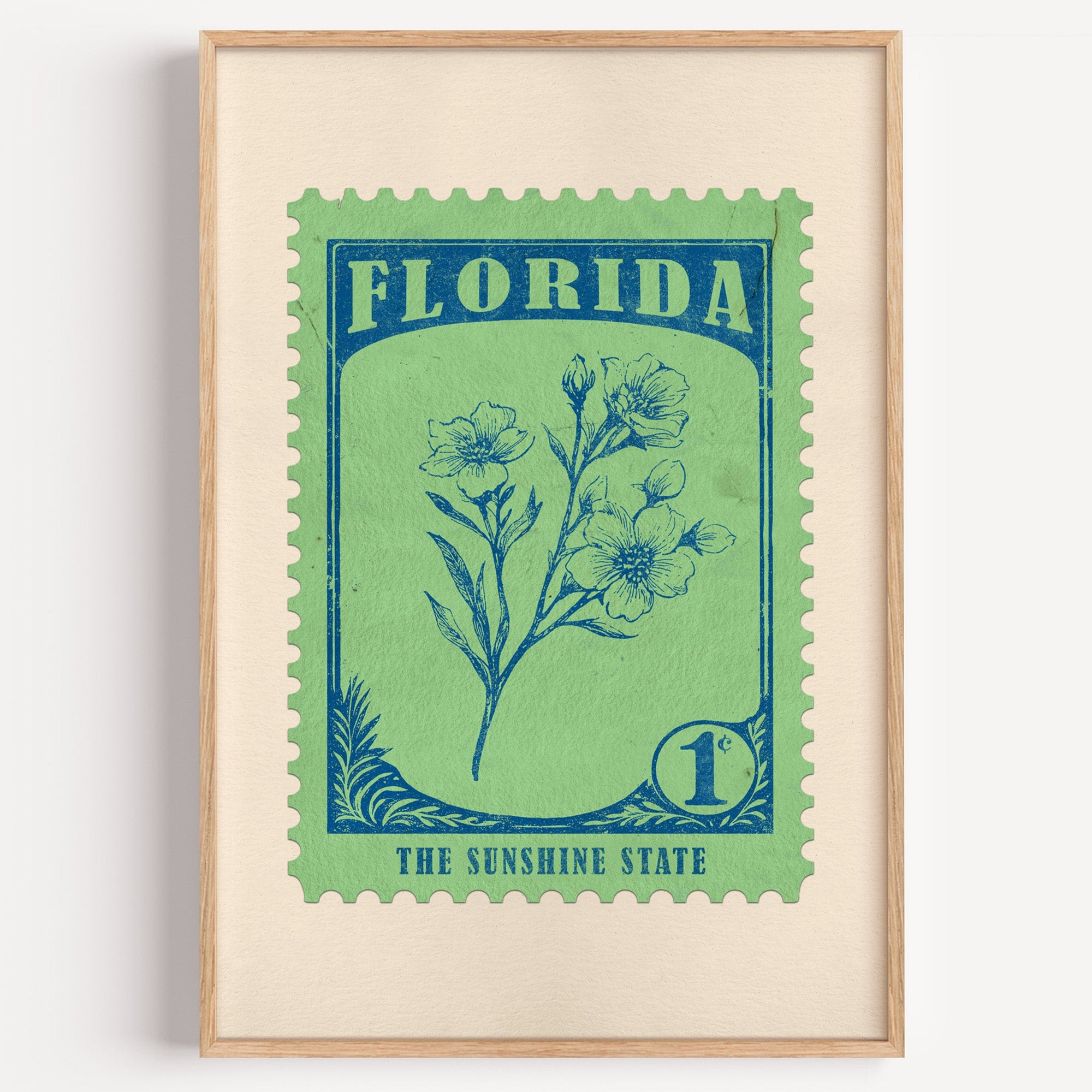 Florida state flower stamp print in petrol blue on spring green, light oak frame on a plain white wall