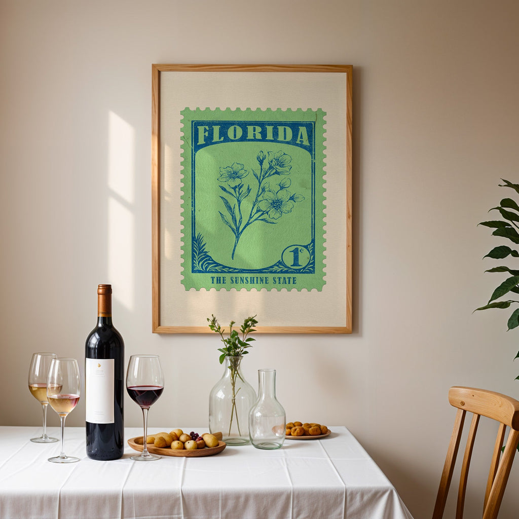 Florida stamp print framed on the wall above a dining table set with wine, glasses and olives
