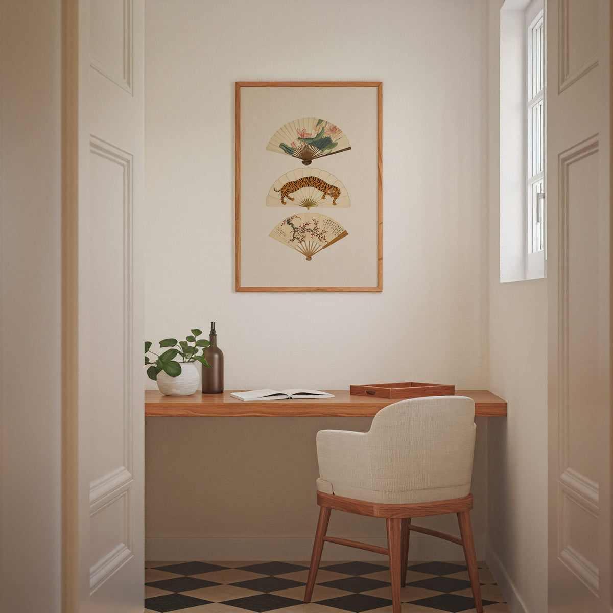 three painted hand fans print in an oak frame above a wall-mounted desk in a home office nook