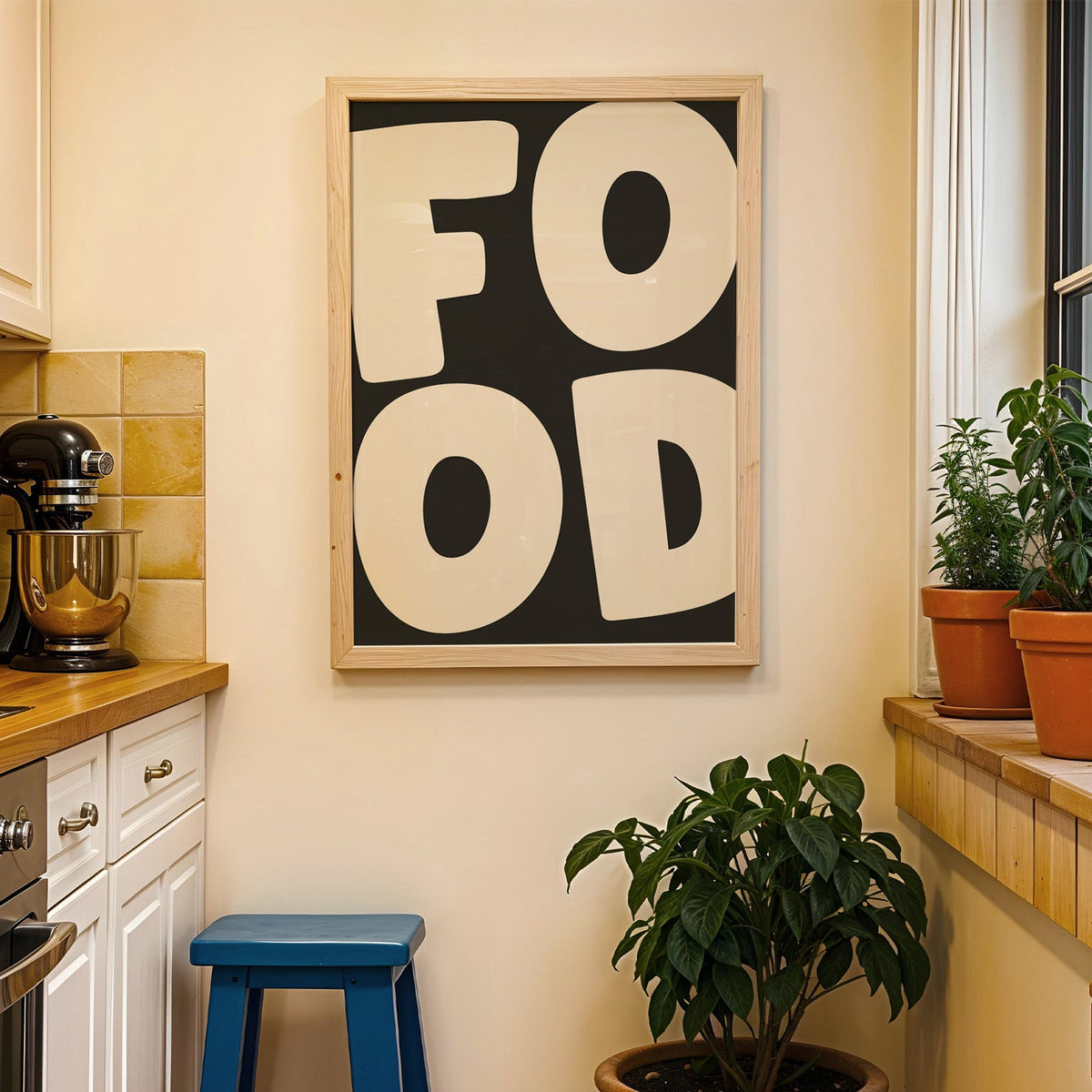 Bold food typography print in a wood frame on a yellow tiled kitchen wall