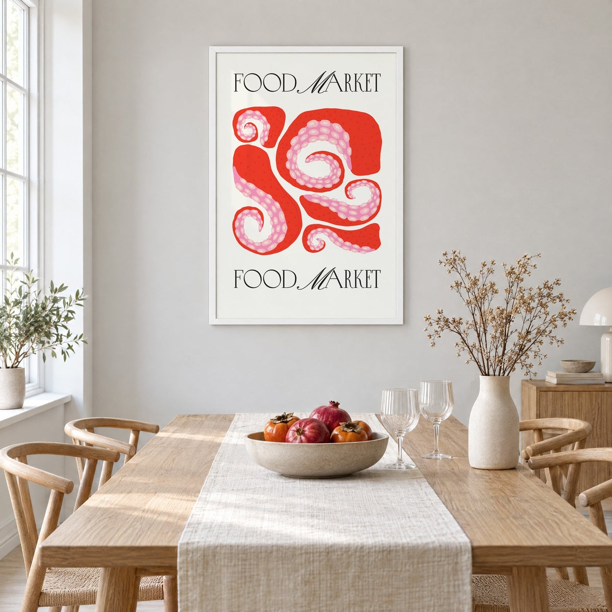 FOOD MARKET red octopus tentacles print in a white frame above a light oak dining table with a linen runner and fruit bowl