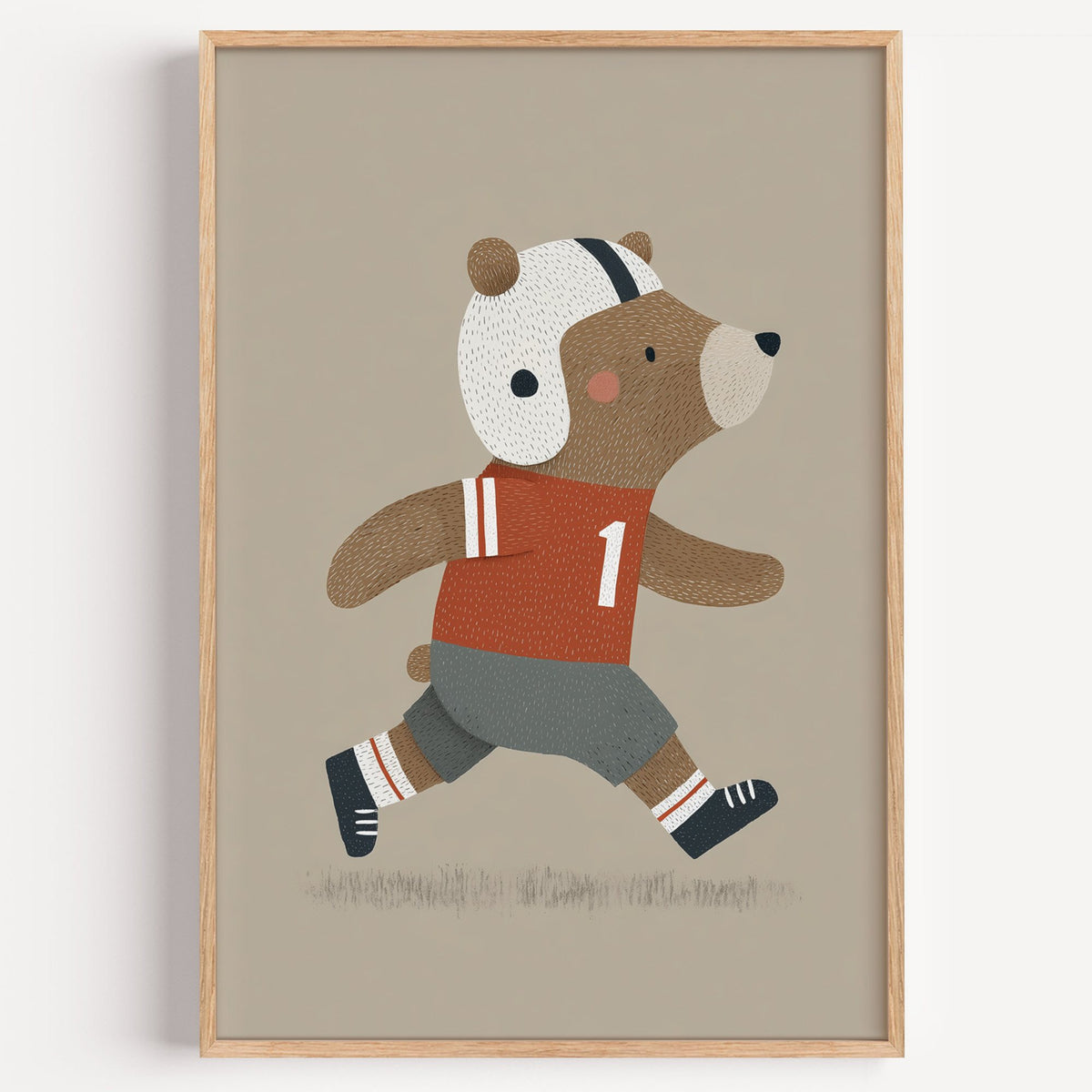 Football bear number one nursery print in a light oak frame on a plain white wall