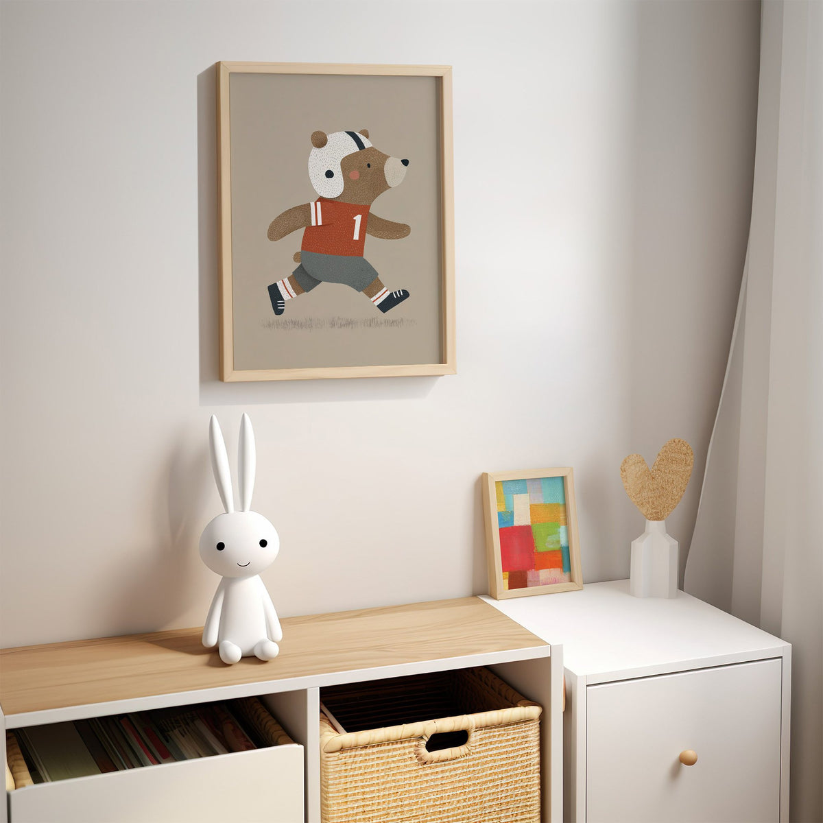 Football bear number one nursery print in an oak frame above a kids cubby shelf with a woven basket and bunny lamp